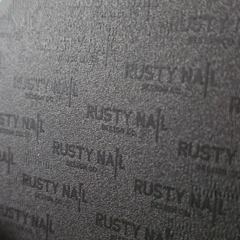 Textured surface with 'Rusty Nail Design Co.' branding