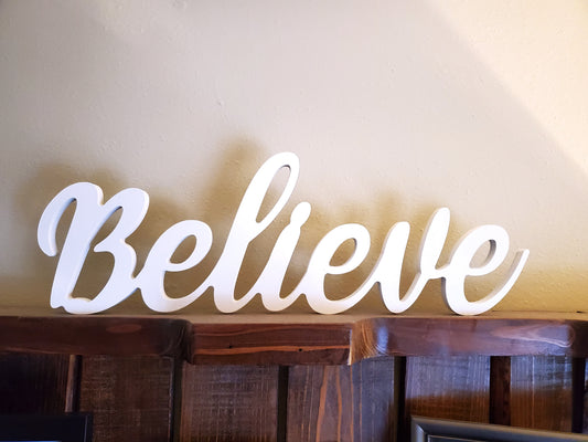 "Believe" script word cutout Christmas decoration